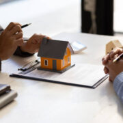 Real estate agent discuss about the terms of the home purchase agreement and asked the customer to sign the documents to make the contract legally, Home sales, lease, mortgage and home insurance.