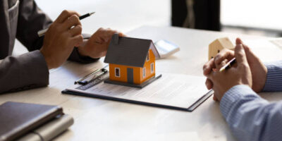 Real estate agent discuss about the terms of the home purchase agreement and asked the customer to sign the documents to make the contract legally, Home sales, lease, mortgage and home insurance.