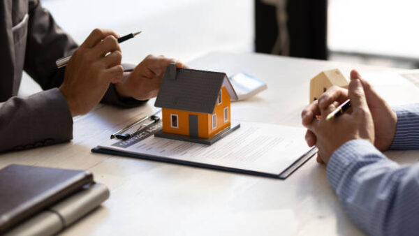 Real estate agent discuss about the terms of the home purchase agreement and asked the customer to sign the documents to make the contract legally, Home sales, lease, mortgage and home insurance.