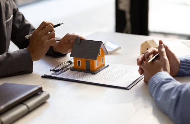 Real estate agent discuss about the terms of the home purchase agreement and asked the customer to sign the documents to make the contract legally, Home sales, lease, mortgage and home insurance.